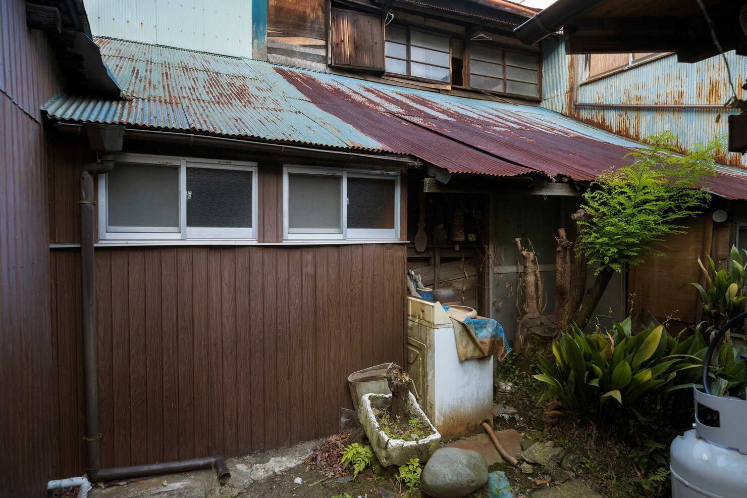 abandoned-house-with-rusty-roof_23-2149454808
